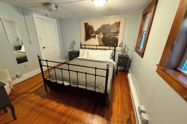 Queen bedroom with hardwood floors and village views