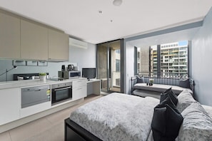 Eine moderne Wohnung mit Küche, Essbereich und Balkon mit Stadtblick.