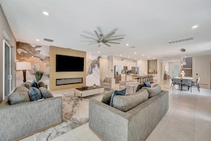 Sink into plush sofas in your spacious, light-filled living area with sleek finishes and an open layout connecting to your dining space and gourmet kitchen—perfect for unwinding or entertaining. - Reunion Resort: 8-Bed Villa, Arcade, Theater, Pool (Kissimmee)