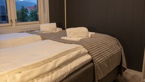 A bedroom with two beds, a window, and a view of mountains. - Arctic Comfort 2, Tromsø (Tromsø)