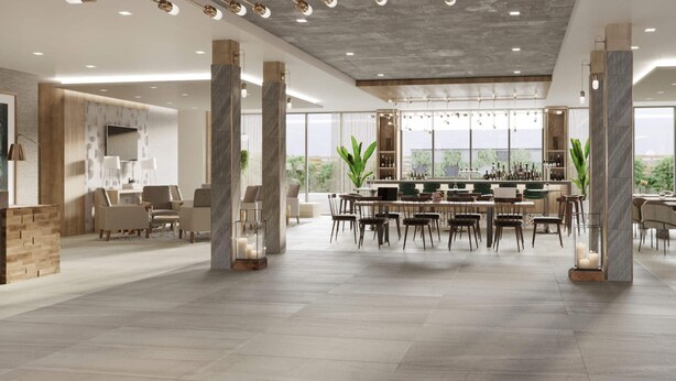 Un espace intérieur vaste et lumineux, doté d’un bar, de coins salon et de grandes fenêtres.