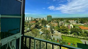 A cityscape with buildings, a clear sky, and a balcony with a view. - Soothing 1-bedroom apartment in vibrant Nairobi perfect for relaxing stay (Nairobi)