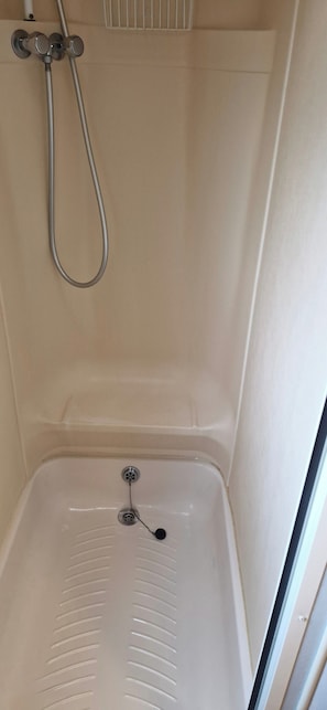 A shower with a handheld showerhead and a drain. - Cabin Sleeps 4 With Parking (Forfar)