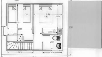 Plano de planta que muestra una cocina, dos dormitorios, un baño y una sala de estar.