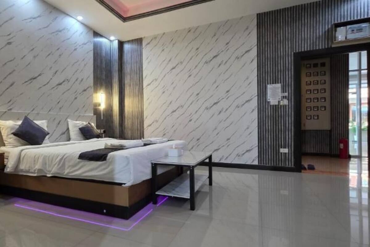 A modern bedroom with a bed, bedside tables, and a nightstand.
