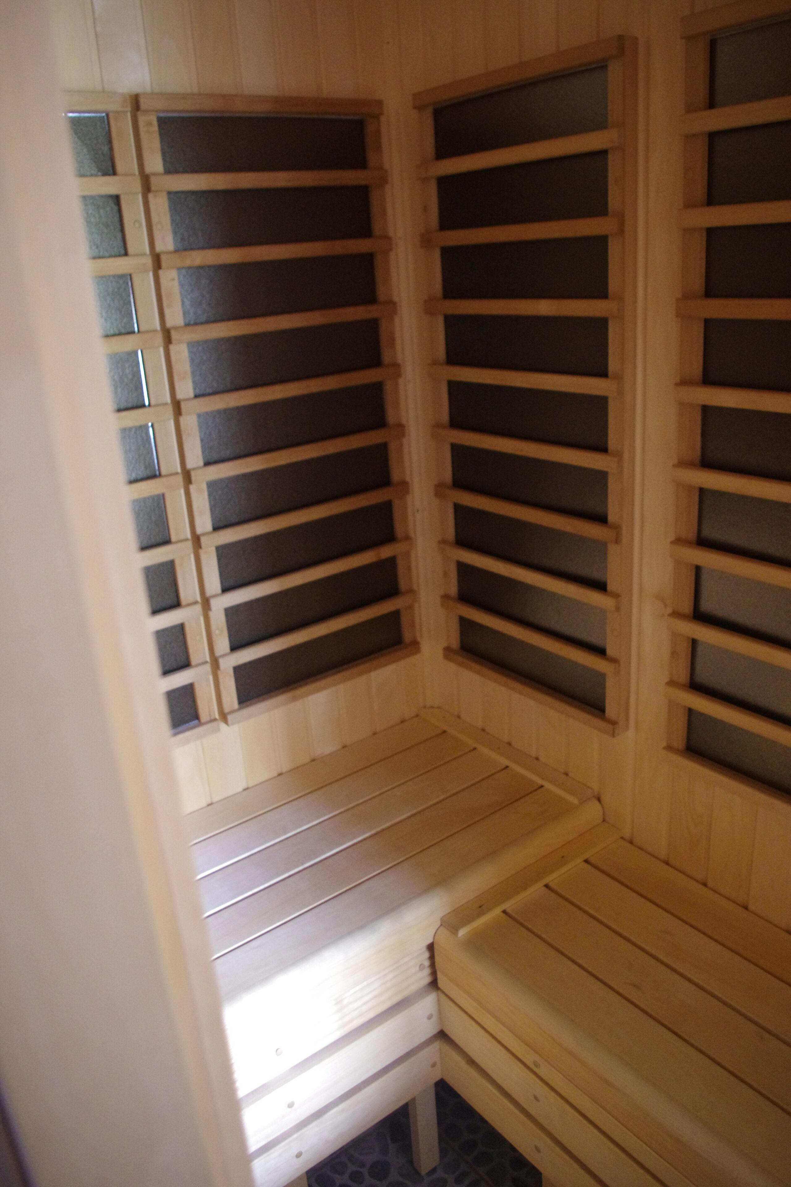 A sauna with wooden benches and slatted walls.