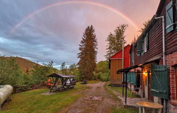 A rustic cabin with a wooden exterior, a covered picnic area, and a stone pathway leading to the entrance. - 10 bedroom amazing home in Sitzendorf (Sitzendorf)