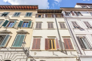 A row of multi-story buildings with various window styles and shutters. - San Marco, Florence By Short Holidays (Florence)