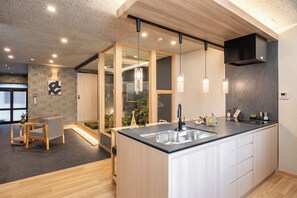 A modern kitchen with a central island, wooden flooring, and pendant lighting. - JAPAVISTA Maverique (KONOHANA WARD)