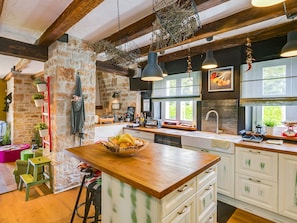 A kitchen with a wooden island, stone walls, hanging lights, and a window with a view. - Villa ARtIEN, 4 bedroom house with swimming pool (Baderna)