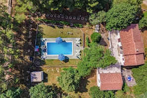 An aerial view of a property with a swimming pool, surrounded by trees and a fenced area. - Pool & Garden House Jaga (Polaca)