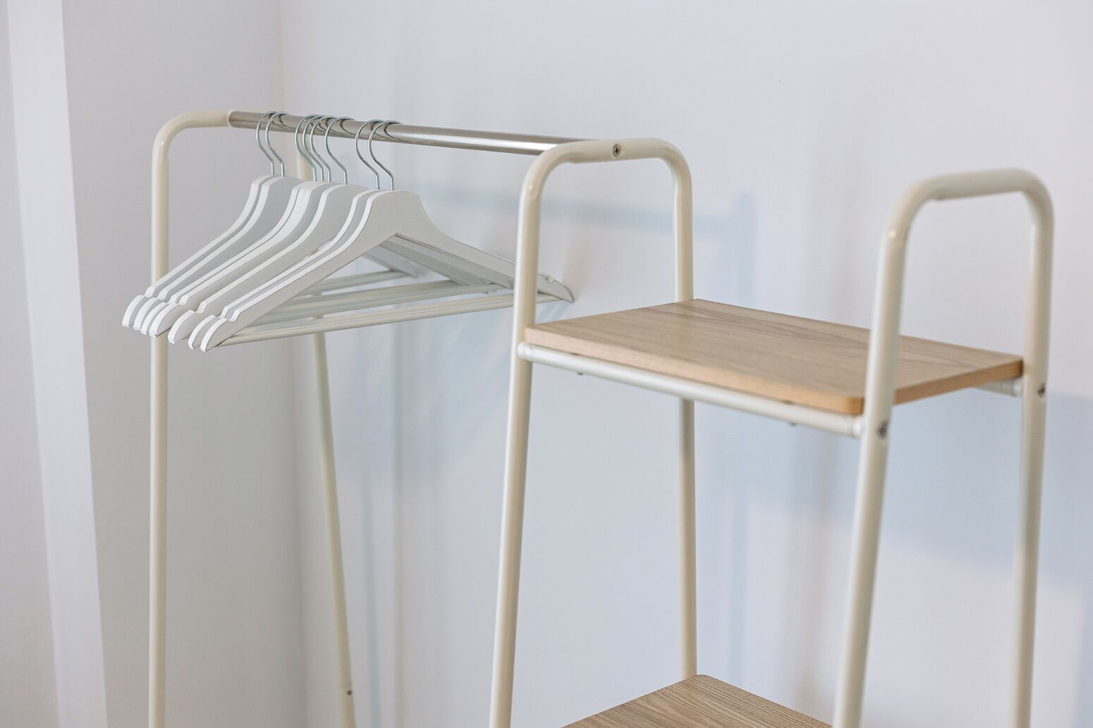 A metal storage unit with shelves and a hanging rack.