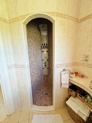 A bathroom with a shower, tiled walls, a sink, and a towel rack. - Luxury Villa with Spa, Sauna, and Billiards Table (Montauroux)