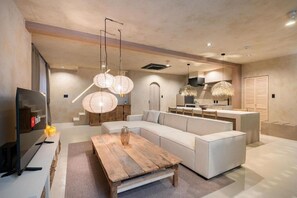 A modern living room with a sectional sofa, wooden coffee table, and hanging paper lanterns. - JAPAVISTA Morino-to (TENGACHAYA, NISHINARI WARD)