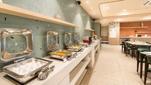 A buffet area with multiple food dispensers and a seating area with tables and chairs. - Amoravida by 7 Apple Resorts Khandala (Lonavala)