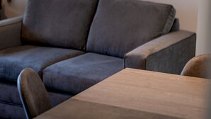 A grey sofa with a wooden coffee table in a room. - Marine Place | Flat 8 (St Andrews)