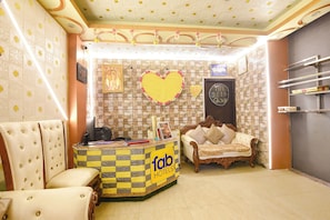 Quarto com balcão xadrez, sofá, coração decorativo e lousa.