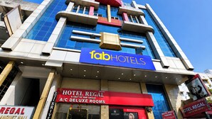 A hotel with a modern facade, a prominent 'fab hotels' sign, and a 'Hotel Regal' sign indicating A/C Deluxe Rooms. - Fabhotel Regal I (Hyderabad)