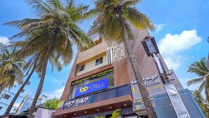 A hotel with a prominent sign for 'Tab Hotels' and a sign for 'Hotel Utsav.' - Via Utsav Grand Inn - RR Nagar (Bangalore)