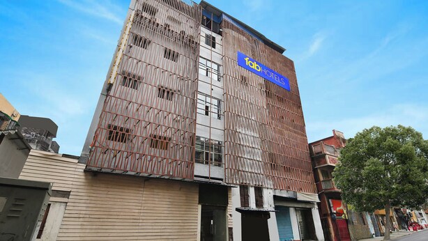A multi-story building with a prominent sign for 'Lab Hotels'. - Fabhotel Stay Hub (Kolkata)