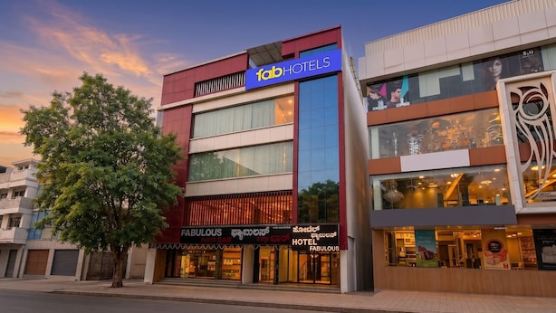 A multi-story building with a prominent 'fab hotels' sign, a 'Fabulous' restaurant/bar, and a 'Hotel Fabulous' sign. - FabHotel Fabulous (Bangalore)