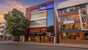 A multi-story building with a prominent 'fab hotels' sign, a 'Fabulous' restaurant/bar, and a 'Hotel Fabulous' sign.
