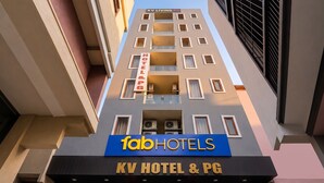 A hotel with a sign reading 'KV Hotel & PG' and 'fabHOTELS' on the facade. - Fabhotel Rv (Noida)