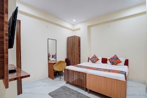 A bedroom with a bed, a wardrobe, a desk, and a chair. - Fabhotel Rv (Noida)