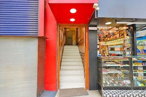 A staircase leading to a shop with a glass display of various items. - Fabhotel Green City Comforts (Bangalore)