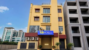 A hotel with a yellow facade, multiple floors, and a sign reading 'fabHOTELS'. - FabHotel Prestige Lake Ridge - Nr Durgam Cheruvu Lake Front Park (Hyderabad)