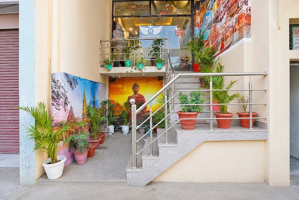 A staircase with metal railings, surrounded by potted plants, leading to a building entrance. - FabHotel Rudransh Residency - 1Km from Kashi Vishwanath Temple (Varanasi)