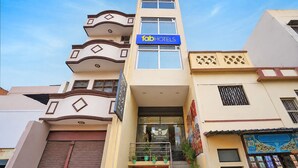 A multi-story building with a 'fab hotels' sign, a 'rudransh residency' sign, and a staircase leading to the entrance. - Fahotel Rudransh Residency-1Km from Kashi Vishwanath Temple (Varanasi)