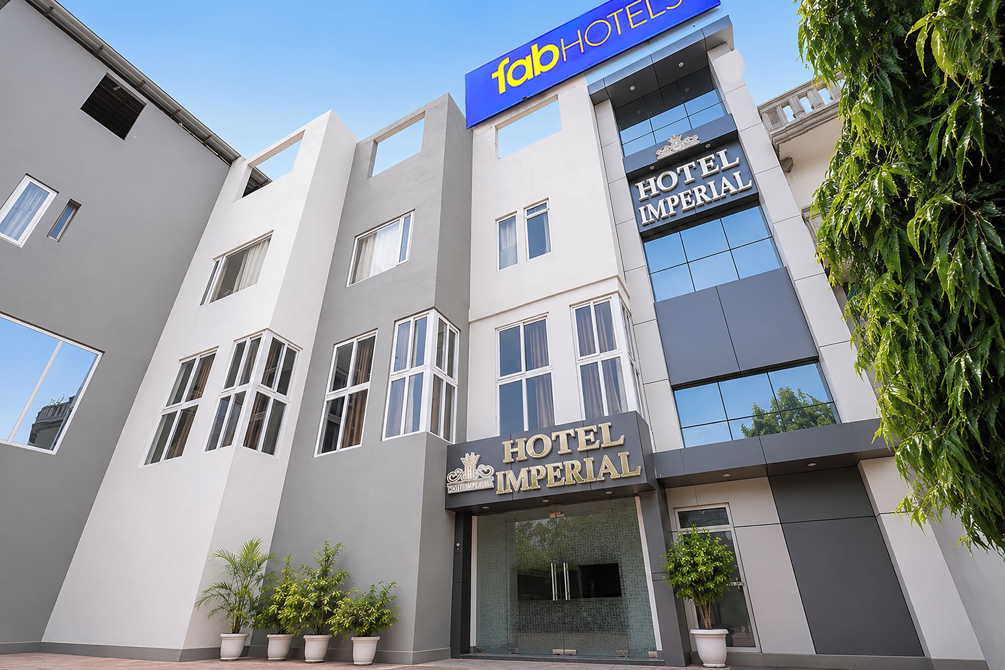 A modern building with a sign reading 'fabHOTEL HOTEL IMPERIAL'.