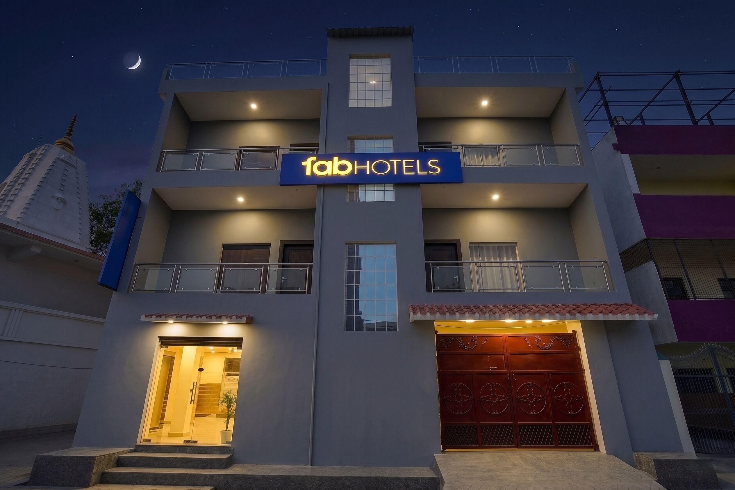 A multi-story hotel with a prominent sign reading 'fabHOTELS'.