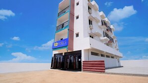 A multi-story hotel with a prominent sign for 'fabHOTELS' on the facade.