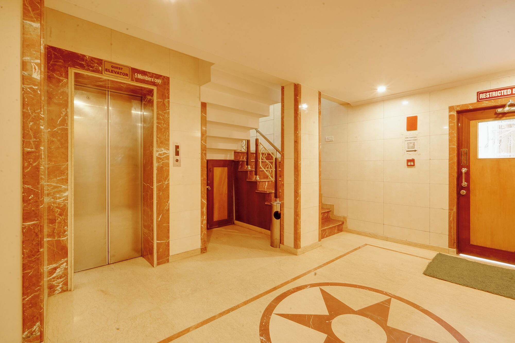 An elevator, a staircase, and a door with a restricted access sign.