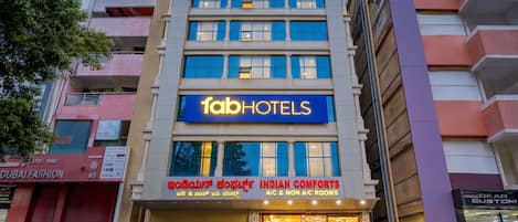 A multi-story building with a prominent 'fabHOTELS' sign.