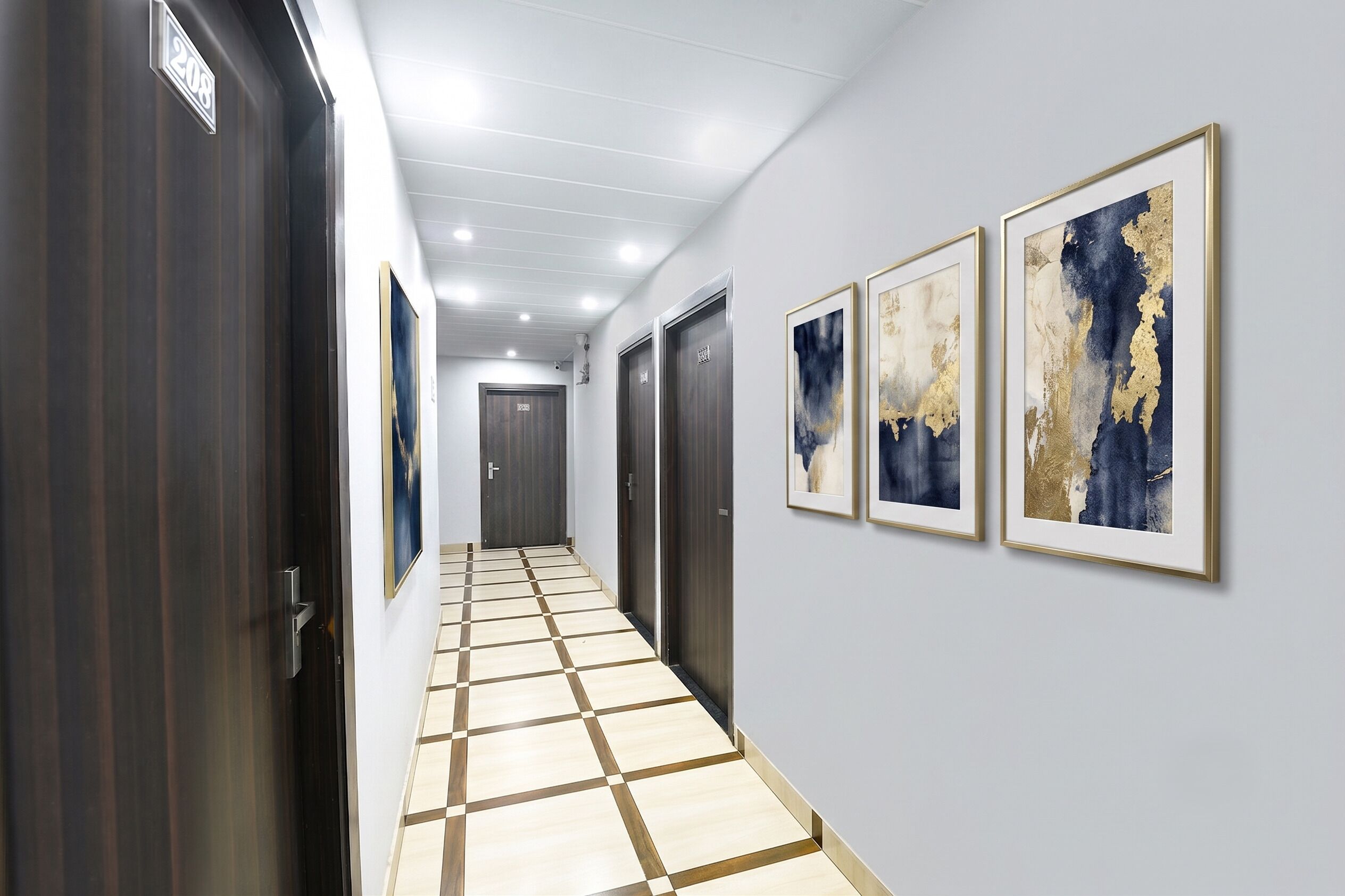 A hallway with a checkered floor, dark wooden doors, and three framed abstract paintings on the wall.