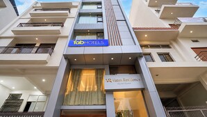 A modern hotel building with a prominent 'fabHOTELS' sign, a 'VR Vatsa Residency' sign, and a multi-story structure with balconies. - Fabhotel Vatsa Residency (Varanasi)