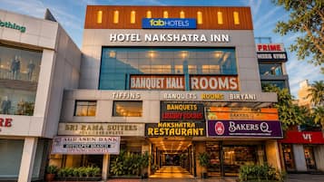 Hotel Nakshatra Inn with a sign for Banquet Hall Rooms and a visible restaurant.