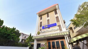 A building with a sign reading 'fabHOTELS Four Boutique' and a sign indicating 'OPEN AIR' below the entrance. - Fabhotel Jd Four Boutique (Jaipur)