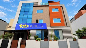 A multi-story hotel with a prominent 'fabHOTELS' sign, a modern architectural design, and a clear sky. - FabHotel La Banian (Indore)
