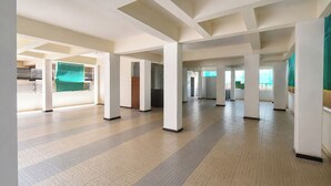 A spacious indoor area with high ceilings, large columns, and a tiled floor. - Via Dazling Studio (Pune)