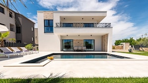 A modern two-story house with a swimming pool, outdoor seating, and a well-maintained lawn. - Villa Kri to Zadarvillas (Privlaka)
