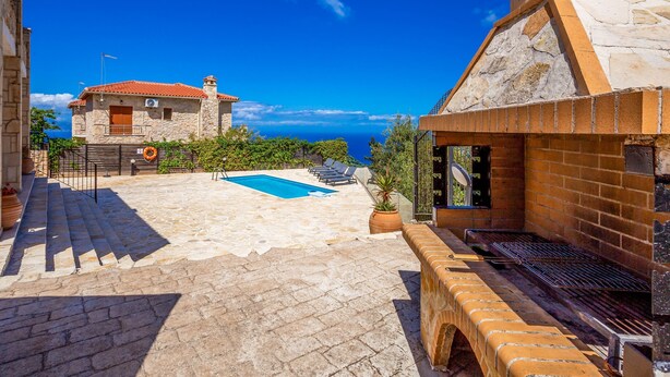 A stone building with a swimming pool, outdoor grill, and a view of the sea. - Sunset Vista Villas Deluxe III (Zakynthos)