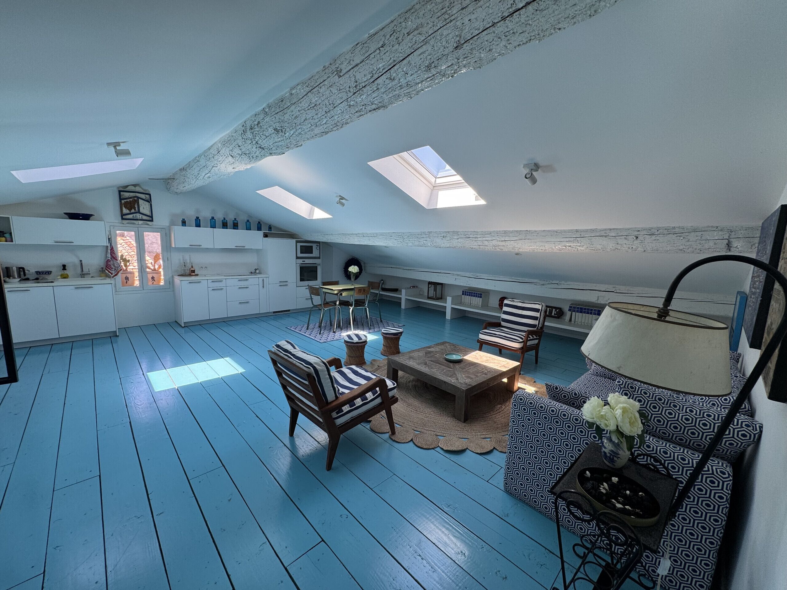 A spacious loft with a kitchen, dining area, and seating.