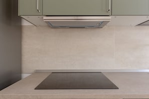 A kitchen with a countertop, cabinets, and a range hood. - Domio | Italian Summer by the Sea (Lido di Camaiore)