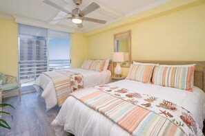 A hotel room with two beds, a ceiling fan, a window with a view, and a nightstand with a lamp. - North Hampton 901 Oceanfront in/out pool/Beach (Myrtle Beach)