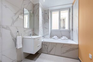 A modern bathroom with marble walls, a double sink vanity, a shower, and a window with a view. - 2. Two bedrooms#Champs-Élysées#Arc de Triomphe#AC (Paris)