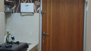 Una cocina con estufa, lavamanos y alacena.